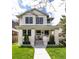 Charming two-story home with inviting front porch and manicured lawn on a sunny day at 619 S Gilpin St, Denver, CO 80209