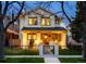 Charming two-story home with inviting front porch and manicured lawn at twilight at 619 S Gilpin St, Denver, CO 80209