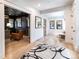 Open foyer leading to an office and a seating area with wood floors at 619 S Gilpin St, Denver, CO 80209