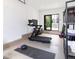 Bright gym with exercise equipment, sliding glass doors and a view of the backyard at 619 S Gilpin St, Denver, CO 80209