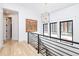 Bright hallway with contemporary chandelier and modern staircase at 619 S Gilpin St, Denver, CO 80209