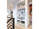 Hallway nook with display shelves looking toward kitchen and powder room at 619 S Gilpin St, Denver, CO 80209