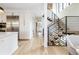 Open-concept interior with staircase, leading to kitchen and wood floors at 619 S Gilpin St, Denver, CO 80209