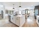 Open concept kitchen island with sink, seamlessly connects to living room with fireplace at 619 S Gilpin St, Denver, CO 80209
