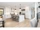 Modern white kitchen features a large island, stainless steel appliances, and pendant lighting at 619 S Gilpin St, Denver, CO 80209