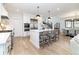 Bright kitchen with an island, stainless appliances, bar stool seating and stairs in view at 619 S Gilpin St, Denver, CO 80209