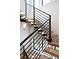 Modern staircase with wood treads, black metal railings, and natural light at 619 S Gilpin St, Denver, CO 80209