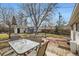 Backyard featuring a deck, patio, lawn, and recreational equipment, ideal for outdoor enjoyment and entertainment at 5668 S Foresthill St, Littleton, CO 80120