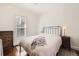 Serene bedroom with natural light, neutral tones, and hardwood floors at 5668 S Foresthill St, Littleton, CO 80120