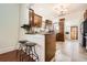 Bright kitchen featuring an island with bar seating and wood accents at 5668 S Foresthill St, Littleton, CO 80120