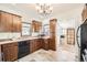 Well-lit kitchen showcasing wood cabinets, tile floors, and stainless steel appliances at 5668 S Foresthill St, Littleton, CO 80120