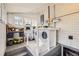 Well-organized laundry room with a modern washer and dryer, shelving, and natural light from multiple windows at 5668 S Foresthill St, Littleton, CO 80120