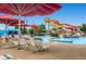 Community pool featuring water slides, lounge chairs, and a lifeguard for residents' enjoyment and relaxation at 5668 S Foresthill St, Littleton, CO 80120