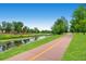 Scenic walking path alongside a tranquil river with lush greenery and trees, perfect for outdoor activities at 5668 S Foresthill St, Littleton, CO 80120