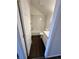 Small bathroom features a white tiled shower and tub combo and a dark brown wood floor at 15555 E 40Th Ave # 11, Denver, CO 80239
