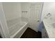 A bathroom with tub, white tile, and modern vanity at 15555 E 40Th Ave # 11, Denver, CO 80239