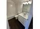 Small bathroom features a white tiled shower and tub combo with a marble sink top at 15555 E 40Th Ave # 11, Denver, CO 80239