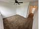A carpeted bedroom featuring a ceiling fan and closet at 15555 E 40Th Ave # 11, Denver, CO 80239