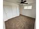 A bright bedroom with carpet, a ceiling fan, and closet at 15555 E 40Th Ave # 11, Denver, CO 80239