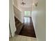 Inviting entryway with hardwood flooring, staircase, and an open view into the living area at 15555 E 40Th Ave # 11, Denver, CO 80239