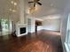 Spacious living room with hardwood floors, fireplace, and ample natural light, open to dining and kitchen at 15555 E 40Th Ave # 11, Denver, CO 80239