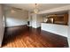 Open living space with fireplace, hardwood floors and bright interior adjacent to kitchen area at 15555 E 40Th Ave # 11, Denver, CO 80239
