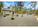 Spacious backyard featuring gravel, firepit, seating area, lush greenery, and a charming guest house at 10887 Goodheart Ave, Conifer, CO 80433