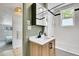 Bright bathroom featuring a modern vanity, bathtub with shower, and stylish fixtures at 10887 Goodheart Ave, Conifer, CO 80433