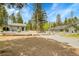 Charming home with a guest house surrounded by a gravel yard, offering a blend of comfort and outdoor living at 10887 Goodheart Ave, Conifer, CO 80433