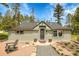 Charming home with a stone walkway, lush landscaping, and a relaxing chair on the front porch at 10887 Goodheart Ave, Conifer, CO 80433