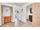 Inviting hallway with wood floors, closet, bathroom, and white-painted walls offers a clean, well-lit transition between spaces at 10887 Goodheart Ave, Conifer, CO 80433