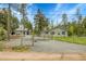 Charming home with mature trees, fenced yard, and gravel driveway offers a serene and private setting at 10887 Goodheart Ave, Conifer, CO 80433