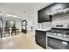Spacious kitchen with stainless steel appliances, dark wood cabinets, and hardwood floors at 10887 Goodheart Ave, Conifer, CO 80433