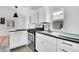 Efficient kitchen with black countertops, stainless steel appliances and ample natural light at 10887 Goodheart Ave, Conifer, CO 80433