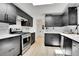 Sleek kitchen featuring stainless steel appliances, dark cabinetry, and a bright, open layout at 10887 Goodheart Ave, Conifer, CO 80433