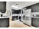 Modern kitchen with stainless steel appliances, dark cabinetry, and a bright skylight at 10887 Goodheart Ave, Conifer, CO 80433