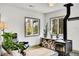 Cozy living room area with a wood-burning stove, hardwood floors, and natural light at 10887 Goodheart Ave, Conifer, CO 80433