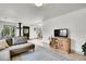 Bright living room with wood floors and a stylish TV console with firewood storage at 10887 Goodheart Ave, Conifer, CO 80433