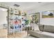 Comfortable living room featuring a brick accent wall and modern bookshelf at 10887 Goodheart Ave, Conifer, CO 80433