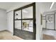 Office with a desk and a window showcasing the exterior view, accessible via a wooden-framed glass door at 10887 Goodheart Ave, Conifer, CO 80433