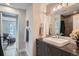 Bathroom featuring a vanity, modern fixtures, a stylish mirror, and a shower with elegant tile at 1895 York St, Denver, CO 80206