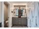 Bright bathroom with double sinks, modern lighting, and a gray vanity with plenty of storage at 1895 York St, Denver, CO 80206