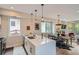 Modern kitchen features an island with a sink and seating that opens to the dining area at 1895 York St, Denver, CO 80206