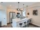Bright kitchen featuring modern pendant lighting, stainless steel appliances, and bar stool seating at 1895 York St, Denver, CO 80206