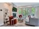 Cozy living room with a fireplace, balcony, and stylish furnishings at 1895 York St, Denver, CO 80206