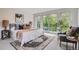 Bright bedroom with large windows, a cozy chair, and access to a private balcony at 1895 York St, Denver, CO 80206