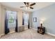 Bedroom with a ceiling fan, natural light, and a light blue accent wall at 8953 Falcon St, Firestone, CO 80504