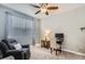 Comfortable bedroom features a ceiling fan, recliner, and workstation at 8953 Falcon St, Firestone, CO 80504