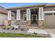 Inviting covered front porch featuring stone accents and a cozy entrance at 8953 Falcon St, Firestone, CO 80504