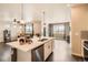 Open-concept kitchen with a center island, stainless steel dishwasher, and seamless layout at 8953 Falcon St, Firestone, CO 80504